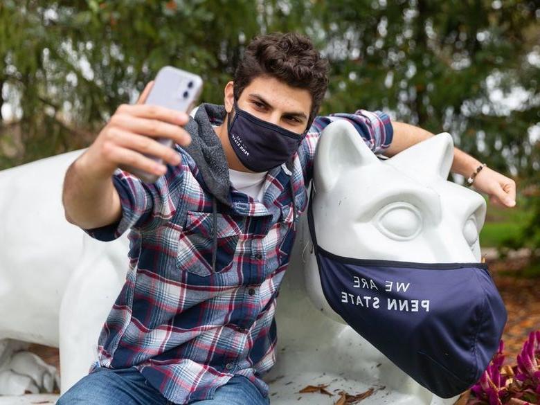 Student taking a selfie with Brandywine lion shrine